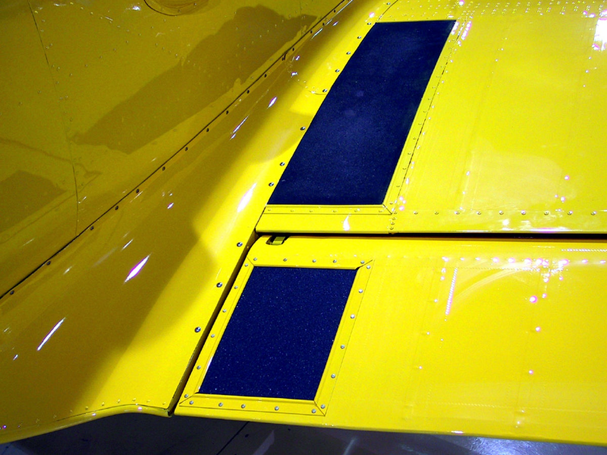 Precision-cut anti-slip traction pads installed on an aircraft surface